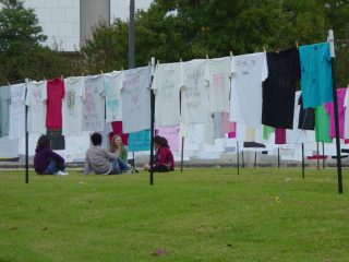 Students studying among the Campus Clothesline Project.
